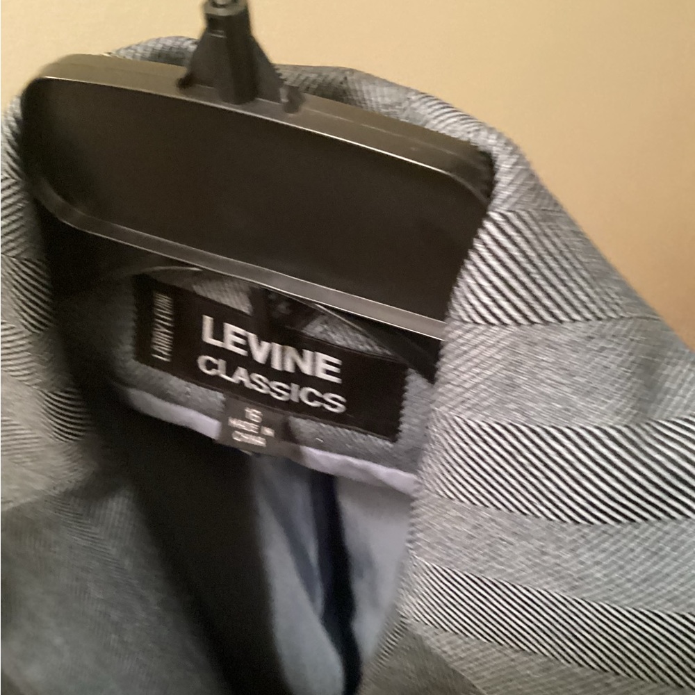 Polyester pant suit. Blue and grey in color with lining.